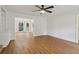 Bright living room with hardwood floors, a ceiling fan, and an open layout to the dining area at 3970 Genoa Ct, Duluth, GA 30096