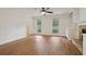 Spacious living room with hardwood floors, a ceiling fan, and abundant natural light from large windows at 3970 Genoa Ct, Duluth, GA 30096