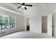 Bedroom featuring a ceiling fan, a walk-in closet, and natural light from large windows at 3970 Genoa Ct, Duluth, GA 30096