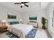 This staged bedroom features a tray ceiling, ceiling fan, and stylish decor at 3970 Genoa Ct, Duluth, GA 30096