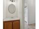 Convenient powder room featuring a vanity with a sink and modern lighting fixtures at 3970 Genoa Ct, Duluth, GA 30096