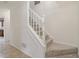 Bright staircase with white railings and neutral carpet leading to the upper level of the home at 3970 Genoa Ct, Duluth, GA 30096