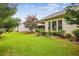 Well-maintained backyard with lush green grass, mature trees, and a covered patio, perfect for outdoor entertaining at 5105 Kings Common Way, Cumming, GA 30040