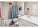 Clean bathroom featuring a white vanity, toilet, and a bathtub with a shower curtain at 5105 Kings Common Way, Cumming, GA 30040