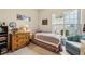 Cozy bedroom featuring a plush armchair, large window, and classic wooden dresser at 5105 Kings Common Way, Cumming, GA 30040
