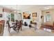 Bright dining area with a round table, classic chandelier, view to the kitchen, and entry way to the home at 5105 Kings Common Way, Cumming, GA 30040