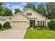 Charming single-Gathering home featuring a two-car garage, manicured lawn, and inviting curb appeal at 5105 Kings Common Way, Cumming, GA 30040