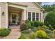 Charming front porch with well-maintained landscaping and a cozy seating area at 5105 Kings Common Way, Cumming, GA 30040
