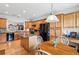 Bright kitchen with wooden cabinets, black appliances, an island, and a breakfast nook at 5105 Kings Common Way, Cumming, GA 30040