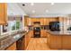 Spacious kitchen with black appliances, granite countertops, and a breakfast bar island at 5105 Kings Common Way, Cumming, GA 30040