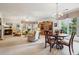 Spacious living room featuring neutral-toned seating under a classic chandelier and large bright windows at 5105 Kings Common Way, Cumming, GA 30040