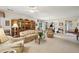 Open concept living room and dining area with large windows providing ample natural light and backyard views at 5105 Kings Common Way, Cumming, GA 30040
