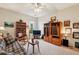 Bright living room with a ceiling fan, built-in shelving, and a comfortable plaid sofa at 5105 Kings Common Way, Cumming, GA 30040