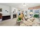 Comfortable living room with fireplace, neutral tones, large windows, and cozy seating arrangements at 5105 Kings Common Way, Cumming, GA 30040
