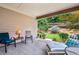 Covered patio with seating, offering a relaxing outdoor space overlooking a landscaped yard with greenery at 5105 Kings Common Way, Cumming, GA 30040