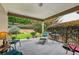 Relaxing covered patio with seating and a view of the backyard landscaping, perfect for outdoor enjoyment at 5105 Kings Common Way, Cumming, GA 30040