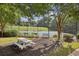 Community tennis courts with benches and shaded seating areas at 5105 Kings Common Way, Cumming, GA 30040