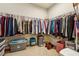 Large walk-in closet providing ample storage space with hanging racks and shelves for organized storage at 5105 Kings Common Way, Cumming, GA 30040