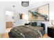 Stylish bedroom features unique artwork, a comfortable bed, and modern lighting at 567 Ponce De Leon Ne Ave # 321, Atlanta, GA 30308
