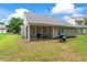 Exterior view of back of home, with screened porch and fenced backyard at 11581 Kades Trl, Hampton, GA 30228