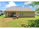 Exterior view of back of home, with screened porch and fenced backyard at 11581 Kades Trl, Hampton, GA 30228