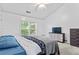 Bright bedroom with a large window, vaulted ceiling, and modern furnishings at 11581 Kades Trl, Hampton, GA 30228