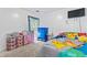 Colorful bedroom with vibrant decor, TV and carpeted floors at 11581 Kades Trl, Hampton, GA 30228