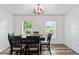 Elegant dining room with a stylish chandelier, table with seating for six, and natural light at 11581 Kades Trl, Hampton, GA 30228