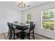Elegant dining room with a stylish chandelier, table with seating for six, and natural light at 11581 Kades Trl, Hampton, GA 30228