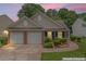 Charming single Gathering home with brick and siding exterior, two-car garage and landscaped yard at 11581 Kades Trl, Hampton, GA 30228