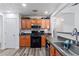 Well-equipped kitchen with stainless steel appliances, wood cabinets, and modern countertops at 11581 Kades Trl, Hampton, GA 30228