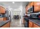 Bright kitchen with stainless steel appliances, modern lighting, and wood cabinets at 11581 Kades Trl, Hampton, GA 30228