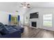 Bright living room features high ceilings, lots of light, and a fireplace at 11581 Kades Trl, Hampton, GA 30228
