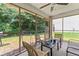 Relaxing screened porch with a ceiling fan and outdoor seating, perfect for enjoying the backyard at 11581 Kades Trl, Hampton, GA 30228