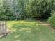 Expansive backyard features lush greenery and mature trees creating a serene and private outdoor oasis at 3290 Spain Rd, Snellville, GA 30039