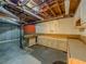 Unfinished basement with cabinets and pegboard for storage, waiting to be transformed at 3290 Spain Rd, Snellville, GA 30039
