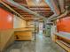 Spacious unfinished basement with exposed pipes and wood beams, ready for transformation at 3290 Spain Rd, Snellville, GA 30039