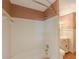 Bright bathroom featuring a tub/shower combo with white tile surround and updated fixtures at 3290 Spain Rd, Snellville, GA 30039