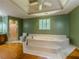 Well-lit bathroom features a garden tub with white tile surround, plus a toilet and shower stall at 3290 Spain Rd, Snellville, GA 30039