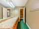 Bathroom with hardwood cabinets, granite countertop, large mirror, and neutral paint at 3290 Spain Rd, Snellville, GA 30039
