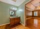 En Suite bathroom with hardwood floors and a sink and vanity with a decorative mirror at 3290 Spain Rd, Snellville, GA 30039