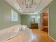 This bathroom has a large soaking tub and a sink and vanity with a decorative window at 3290 Spain Rd, Snellville, GA 30039