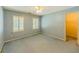 Bedroom with blue walls, blue carpet, white trim, ceiling fan, and a walk-in closet at 3290 Spain Rd, Snellville, GA 30039