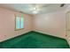 Bedroom with pink walls, green carpet, plantation shutters, ceiling fan, and white trim at 3290 Spain Rd, Snellville, GA 30039