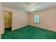 Bedroom with pink walls, green carpet, white trim, ceiling fan, and a closet visible on the left at 3290 Spain Rd, Snellville, GA 30039