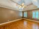 Bedroom with hardwood floors, a ceiling fan, and shuttered windows that bring in natural light at 3290 Spain Rd, Snellville, GA 30039