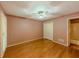 Spacious bedroom features pristine hardwood floors, a ceiling fan, and bright natural light at 3290 Spain Rd, Snellville, GA 30039