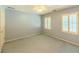 Bedroom with blue walls, blue carpet, white trim, plantation shutters, and white trim at 3290 Spain Rd, Snellville, GA 30039