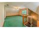 Upstairs bonus room with plush green carpet, a ceiling fan, and a bright window at 3290 Spain Rd, Snellville, GA 30039