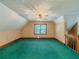Spacious bonus room features plush green carpets, neutral colored walls, and a ceiling fan at 3290 Spain Rd, Snellville, GA 30039